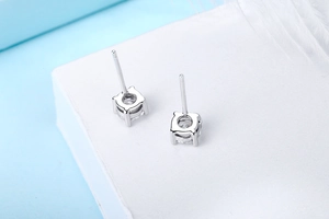 Macro shot of S925 sterling silver stud earrings with classic four-prong diamond setting