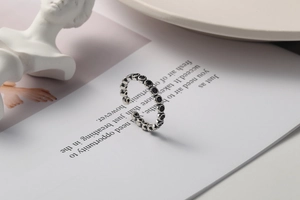 Detail view of vintage S925 sterling silver ring with black zircon in a retro display