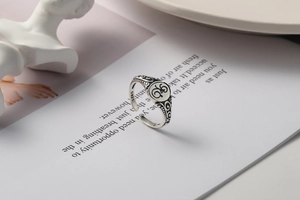 Detail of vintage 925 sterling silver open ring featuring hollow floral patterns