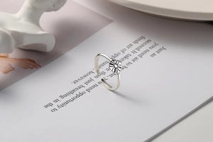 Detailed macro view of S925 sterling silver daisy ring with antique finish and open design