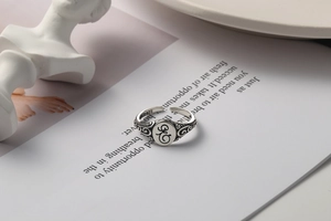 Detailed macro of vintage 925 silver ring featuring engraved monogram and S925 hallmark