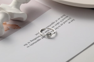 Detailed view of vintage S925 silver daisy ring with antique finish on a magazine
