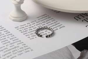 Macro detail of vintage S925 sterling silver ring with black zircon on magazine