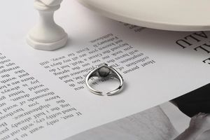 Detailed macro view of retro 925 silver open ring with black inlay and vintage textures