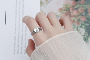 Macro detail of vintage 925 sterling silver signet ring with ornate scroll engraving