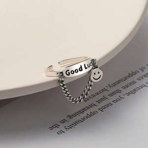 925 silver Good Luck smiley face ring with Cuban chain detail on ceramic plate