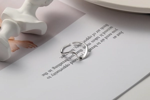 Detail view of S925 sterling silver wavy ring with mirror polished finish on art background