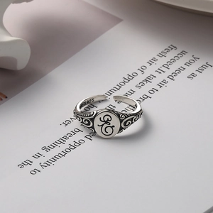 Vintage 925 sterling silver open ring featuring intricate filigree and engraved artistic symbol