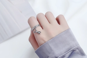 Detail shot of s925 silver chain ring with 3D bunny charm worn on person's hand