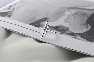 Artistic layout of S925 sterling silver hollow ring placed on a white book and fabric