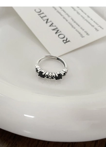 Close-up of S925 sterling silver vintage ring with black stones and Fleur-de-lis motif