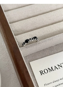 Macro view of vintage S925 silver ring with black gems and hollow cross details