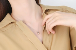 Gros plan du collier en argent S925 avec pendentif goutte d'eau sur un mannequin