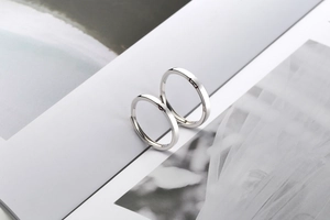 Detail of S925 silver minimalist couple rings with small red heart accents