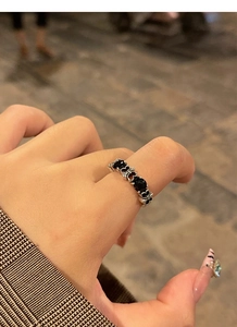 Close-up of vintage S925 silver ring with black gemstone and gothic cross patterns