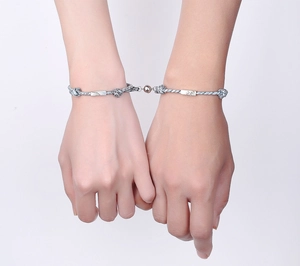 Close-up of magnetic attraction feature on woven couple bracelets in black and white