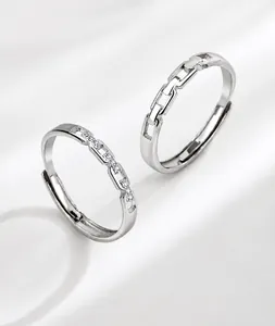 Detailed macro view of interlocking silver rings with pavé stones and adjustable design