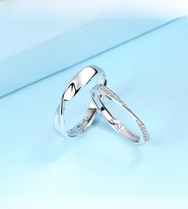 Detail of S925 sterling silver couple rings showing Mobius twist and diamond accents