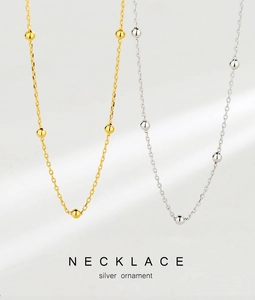 Detailed view of silver and gold beaded choker necklaces with polished s925 silver finish
