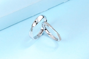Detail of S925 sterling silver Mobius rings with polished finish and diamond accents