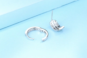 Macro view of S925 sterling silver hoop earrings with clear cubic zirconia channel setting