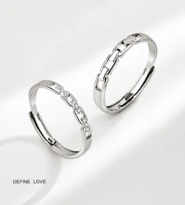 Close-up of interlocking silver rings for couples featuring refined chain-link design