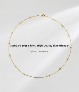 Close-up of S925 sterling silver satellite chain necklace with delicate gold beads
