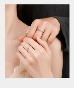 Close-up of interlocking silver couple rings with chain texture and diamond accents