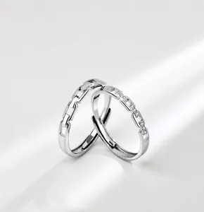 Detail of interlocking silver couple rings with pavé cubic zirconia and chain link design