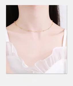 Delicate gold satellite choker necklace with tiny beads shown on a model's neck