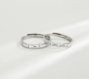 Macro shot of interlocking link pattern silver rings with cubic zirconia settings