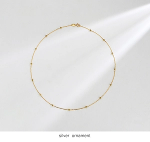 Close-up of minimalist gold plated S925 sterling silver station choker with tiny beads