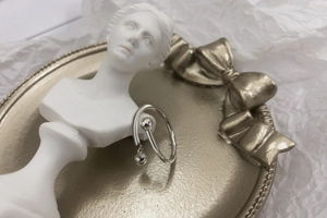 Detailed view of S925 sterling silver cross ring with polished beads and chain dangle