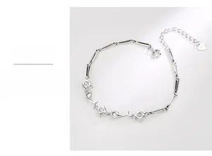 Macro detail of S925 sterling silver dolphin bracelet featuring bamboo chain links