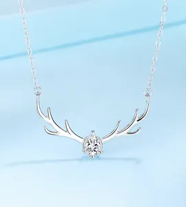 Macro view of S925 sterling silver reindeer necklace with a sparkling pear-cut gemstone