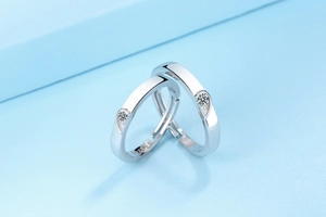 Macro shot of S925 silver couples ring showing half-heart design with tiny zircon stone