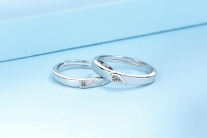 Detail of S925 sterling silver couple rings with polished surface and heart-shaped fitting