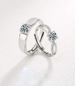 Macro shot of S925 silver couple rings featuring sparkling round diamonds and cross designs