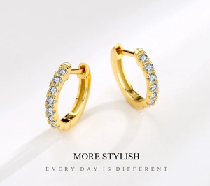 Macro view of gold-plated hoop earrings with micro-pave sparkling cubic zirconia stones