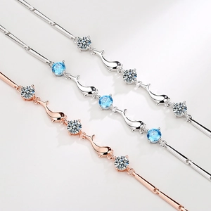 Three elegant dolphin themed S925 silver bracelets with zircon stones on white background