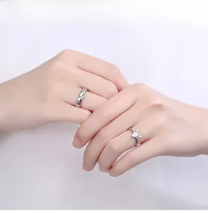 Detail of S925 silver antler couple rings with heart crystal on a female hand model