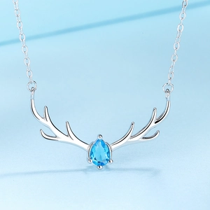 S925 sterling silver reindeer necklace with a blue teardrop pendant on light blue background