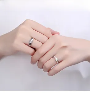 Close-up of S925 silver couple rings with sparkling diamonds on a model's hand