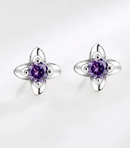 Macro view of S999 silver four-leaf clover stud earrings with purple cubic zirconia