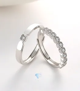 Detail of S925 sterling silver couple rings with adjustable bands and sparkling cubic zirconia