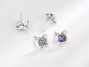 Macro shot of S925 sterling silver four-leaf clover earrings with sparkling cubic zirconia