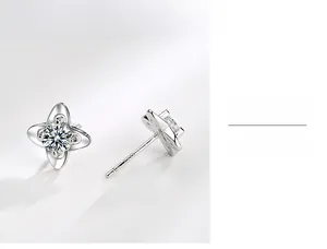 Macro shot of S999 sterling silver clover earrings showing the metal hallmark and zircon inlay