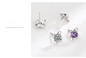 Macro detail of S999 silver four-leaf clover earrings with purple cubic zirconia stones