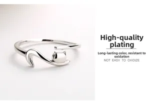 Macro detail of silver S925 plated sleeping cat ring with polished anti-tarnish finish
