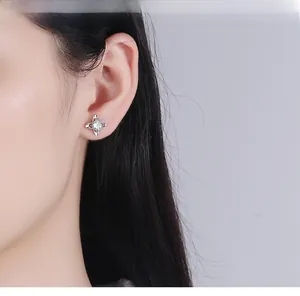 Side view of a female model wearing a S999 sterling silver four-claw clover stud earring
